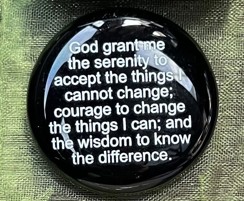 A button with the words " god grant me the serenity to accept the things i cannot change ; courage to change the things i can ; and