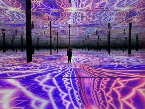 Woman in purple light art installation.