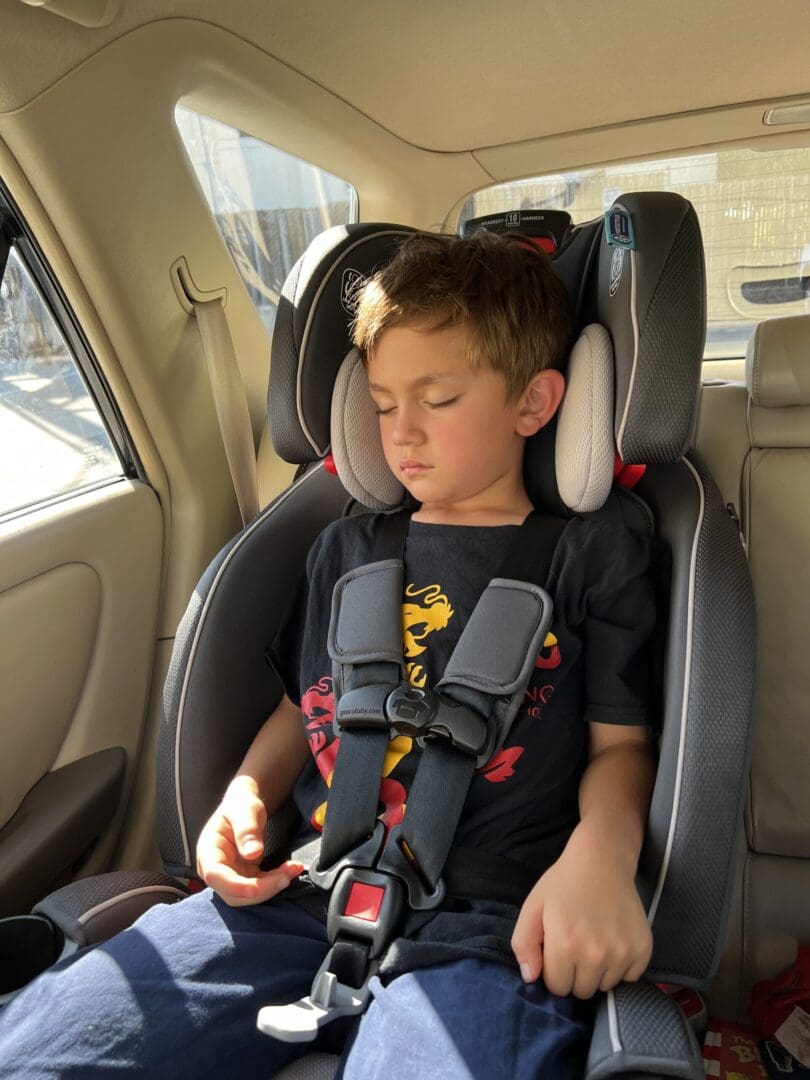 Child sleeping in car seat.